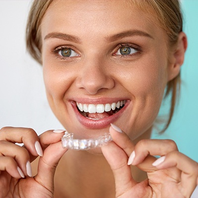 Woman placing an orthodontic appliance