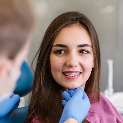 a dentist pointing at a digital impression on a monitor