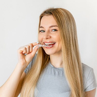 a woman wearing clear braces from her orthodontist in Enfield