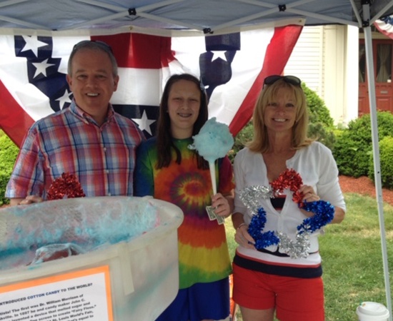 Orthodontist, patient, and team member at community event