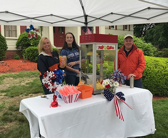 Team members making popcorn at community event