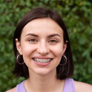 Smiling woman with dentofacial orthopedics appliance in place