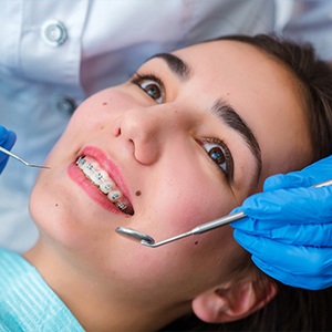 Woman smiling during dentofacial orthopedics treatment visit