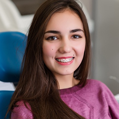 Woman smiling following orthodontic emergency