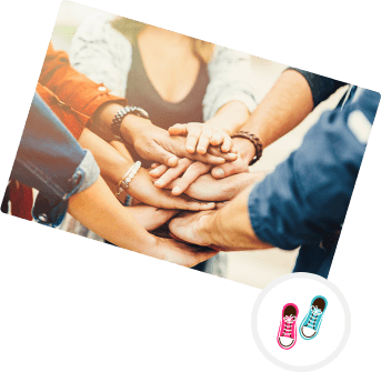 group of people in a circle putting hands together