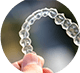 Hand holding an Invisalign clear aligner
