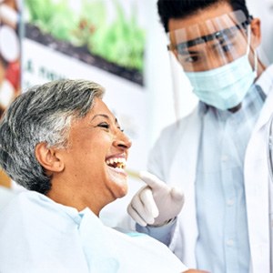 Orthodontist showing patient smile in reflection