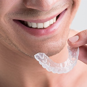 Closeup of person placing an Invisalign clear aligners