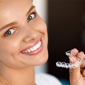 Woman placing an Invisalign tray