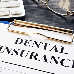 Closeup of dental insurance paperwork for the cost of orthodontic emergencies