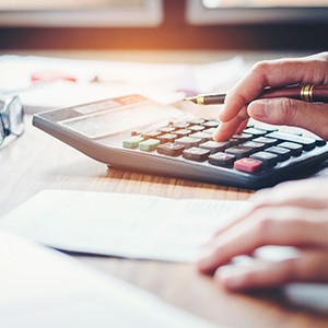 Closeup of Enfield orthodontist calculating the cost of emergency treatment 