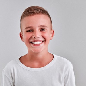 a child smiling after undergoing Phase 1 orthodontics