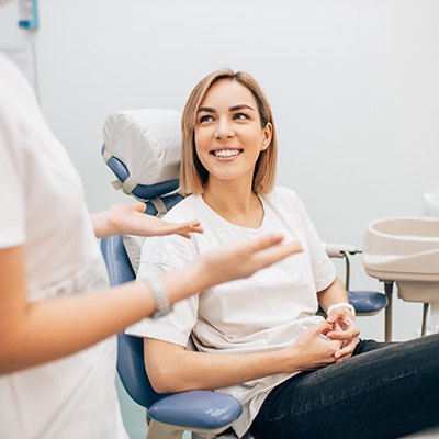 A young woman smiling after completing Spark clear aligners in Enfield