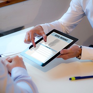 Patient reviewing dental insurance form on tablet