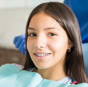 Girl with braces attending orthodontic appointment