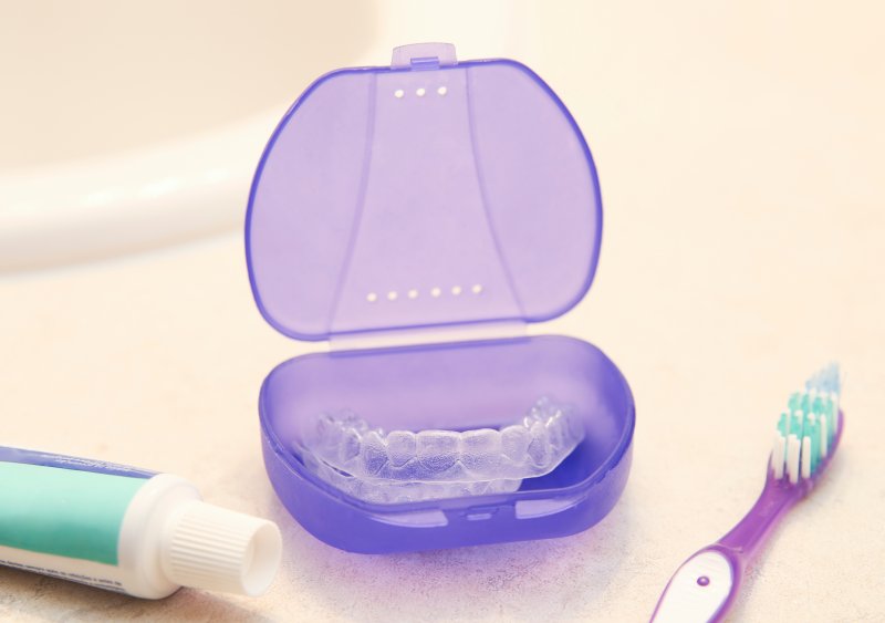 clear aligner resting in a purple case