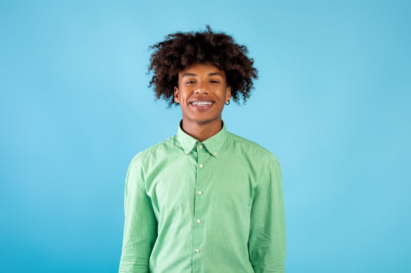 A young man with braces, fully prepared for orthodontic emergencies