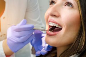 Woman with braces in the dentist's chair. 